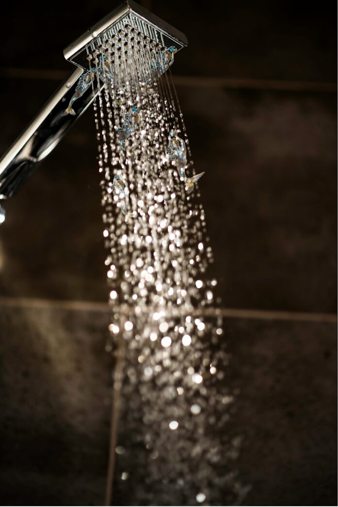 Photo by Ginger Hendee a close up of a shower head with water coming out of it