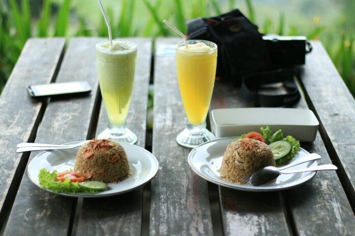 Photo by Ariv Kurniawan fried rice and glass of juices on table