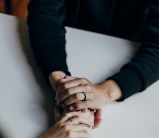 MZ세대를 위한 정신건강 케어, 어떻게 할까? person in black long sleeve shirt holding babys feet