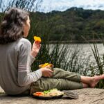 MZ세대가 주목한 ‘마음챙김 식사’, 우리집 밥상에도 실천해볼까? woman in gray long sleeve shirt sitting on brown wooden dock during daytime