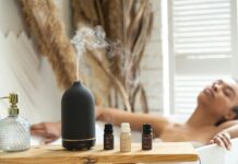 현대인의 일상에 스며드는 대체요법, 내게 맞는 실천 루틴 찾기 a woman laying in a bathtub next to a bottle of essential oils