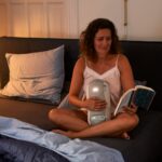 새로운 웰니스 문화, 일상 속 작은 변화가 건강을 바꾼다 woman in white tank top sitting on couch