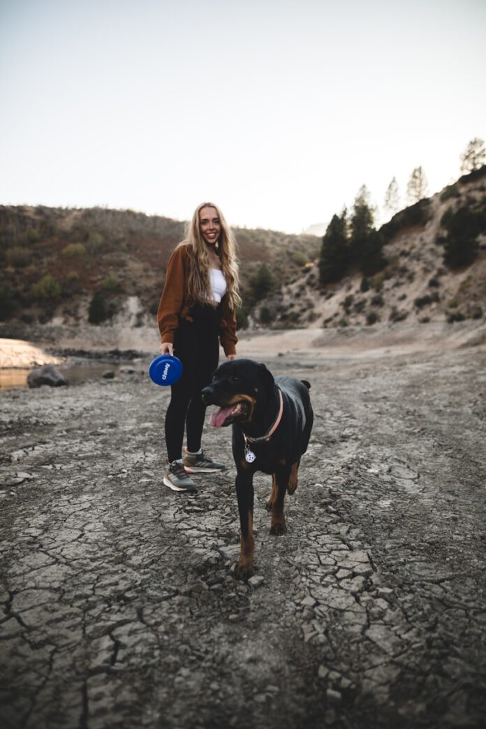 Photo by Chewy woman in black t-shirt holding blue and white ball