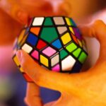 “하루 10분 뇌를 위한 투자”…일상에서 실천하는 뇌건강 트렌드 person holding 3 x 3 rubiks cube