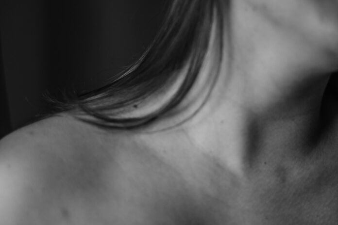 a black and white photo of a woman's back